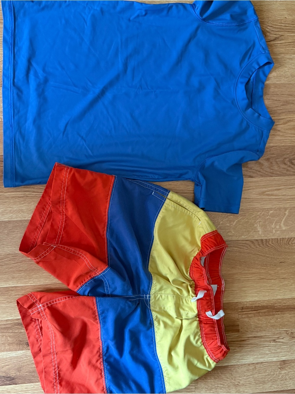 Blue Swim Shirt (Primary) & Colorblock Red/Blue/Yellow Swim Trunks (Hanna Ander)